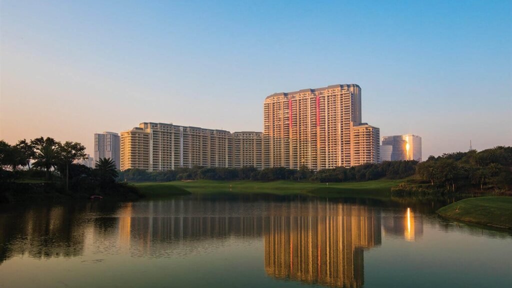 DLF The Camellias towers in Gurugram at dusk, reflected in a lake on the DLF golf course