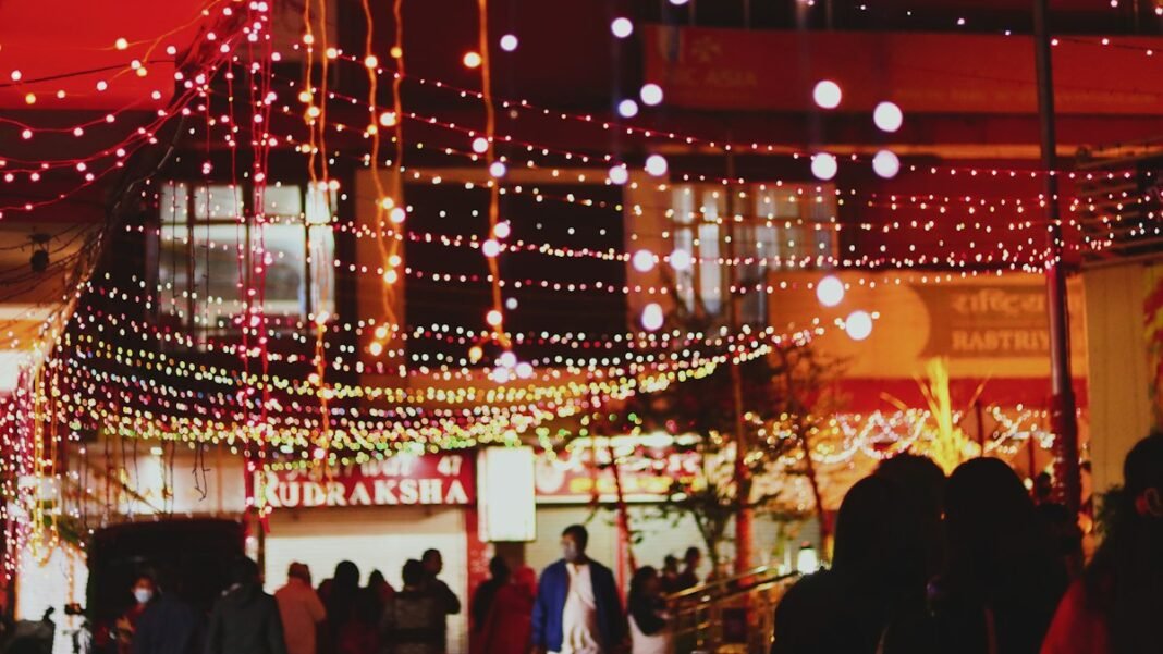 A busy Indian market street lit up with Diwali lights