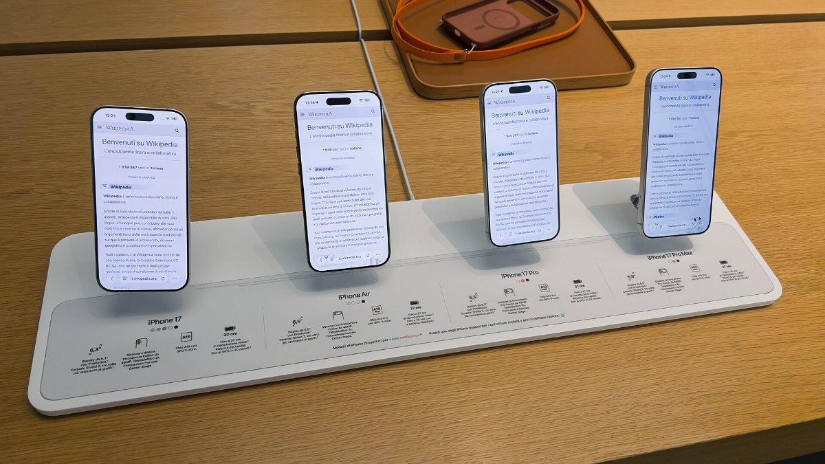 A row of iPhones on display at an Apple Store