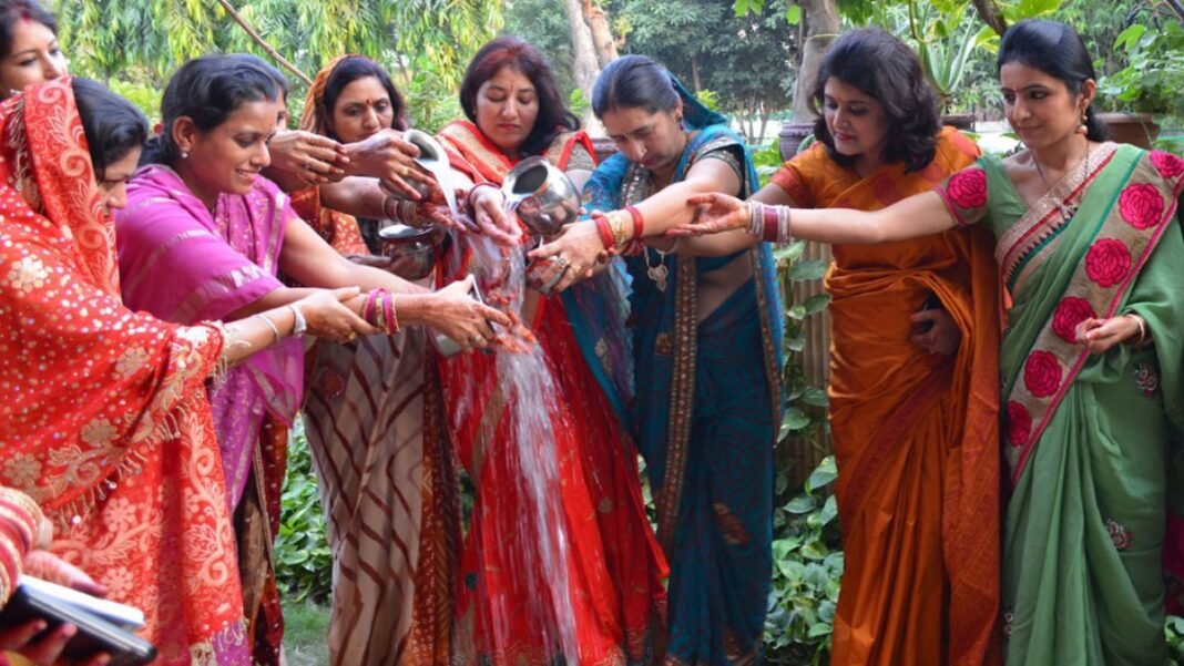 Women performing Karwa Chauth puja together Women performing Karwa Chauth puja together