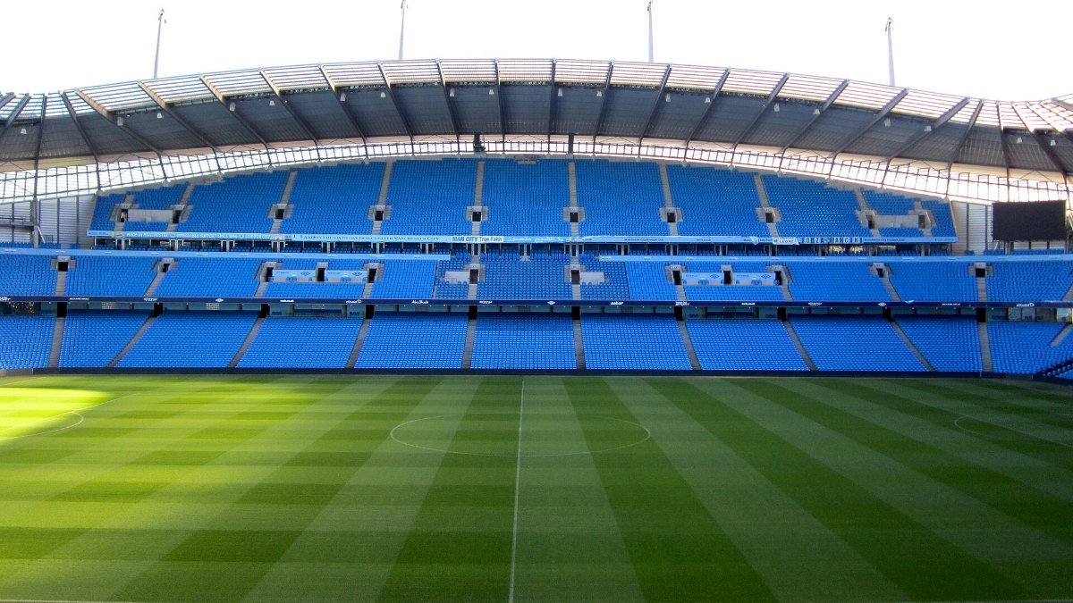 The pitch and blue stands at the Etihad Stadium in Manchester