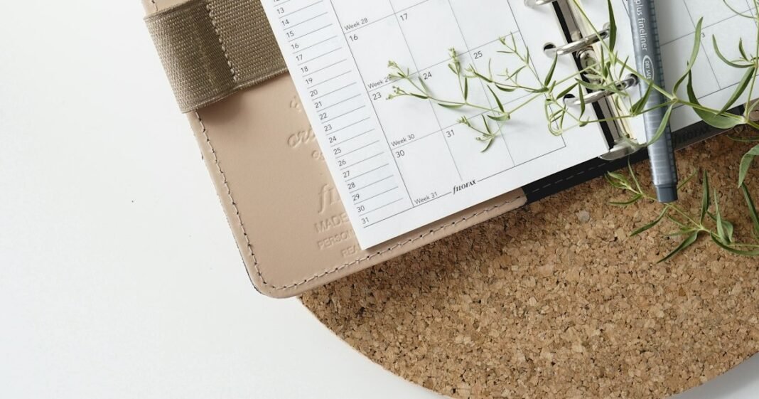 Open planner with a pen on a desk