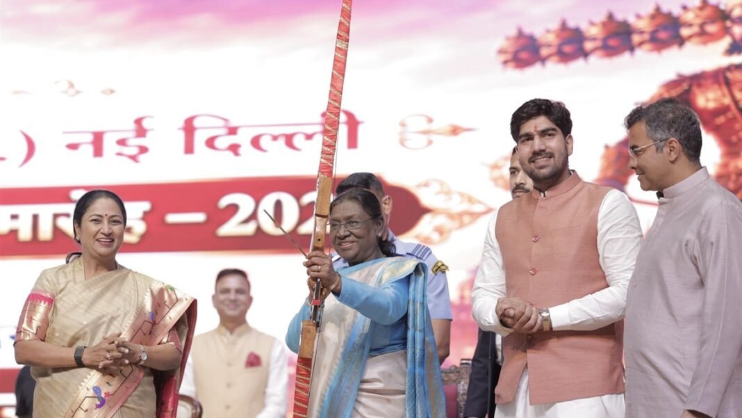 President Smt. Droupadi Murmu holds a bow at the Dwarka Shri Ram Leela on Dussehra 2026