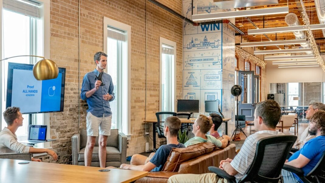 A founder presenting his idea to a group of people in an office