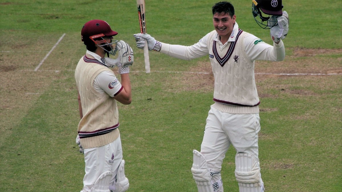 Matt Renshaw raising his bat and helmet after a century