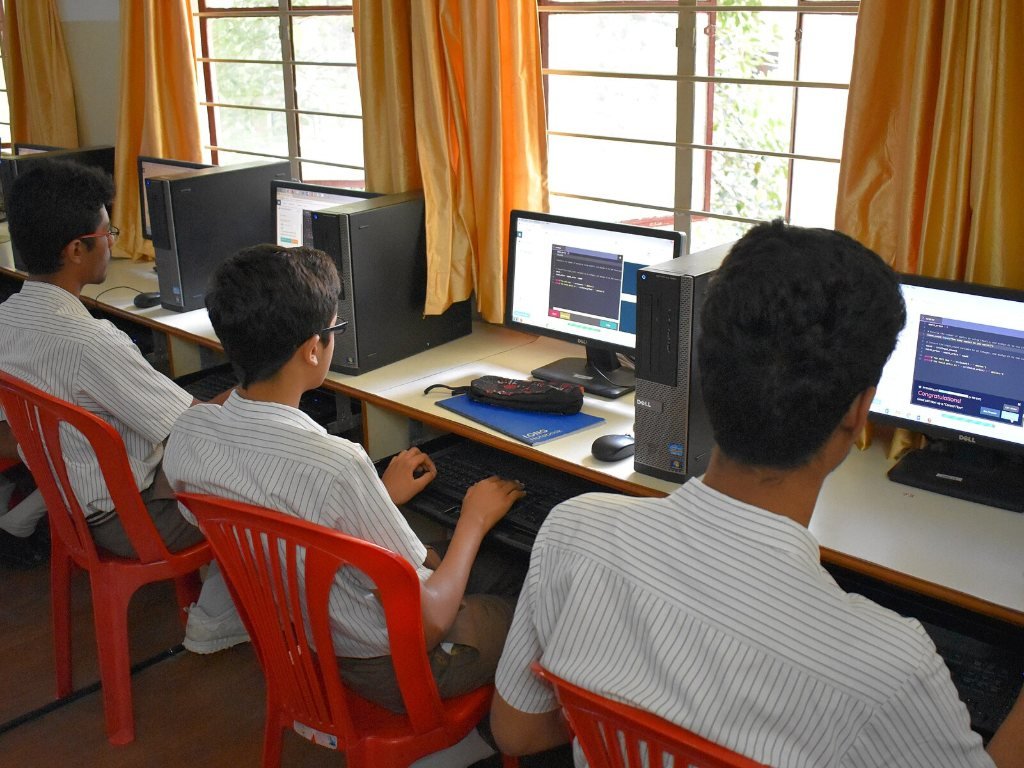 School students in Bengaluru learning to code on laptops